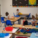 Children playing with educational toys in classroom setting