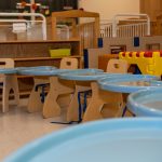 Infant rm3 Preschool classroom with blue tables and wooden chairs
